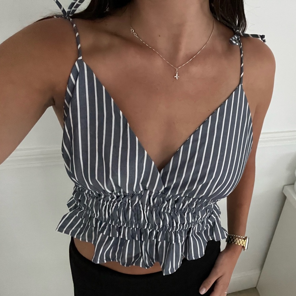 Blue and white striped crop top with cinched body and adjustable straps.
